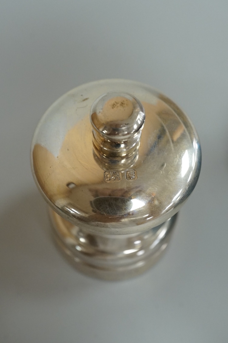 A pair of modern silver pepper mills, by M C Hersey & Son Ltd, London, 1993 & 1995, 7cm, each individually boxed.